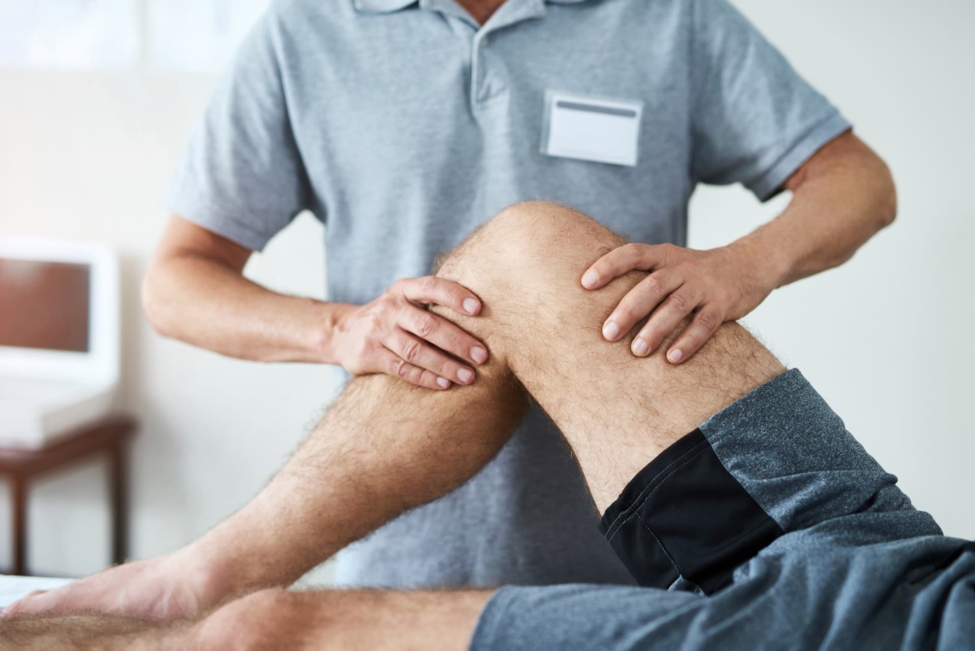 Physical therapist working on a patient's knee