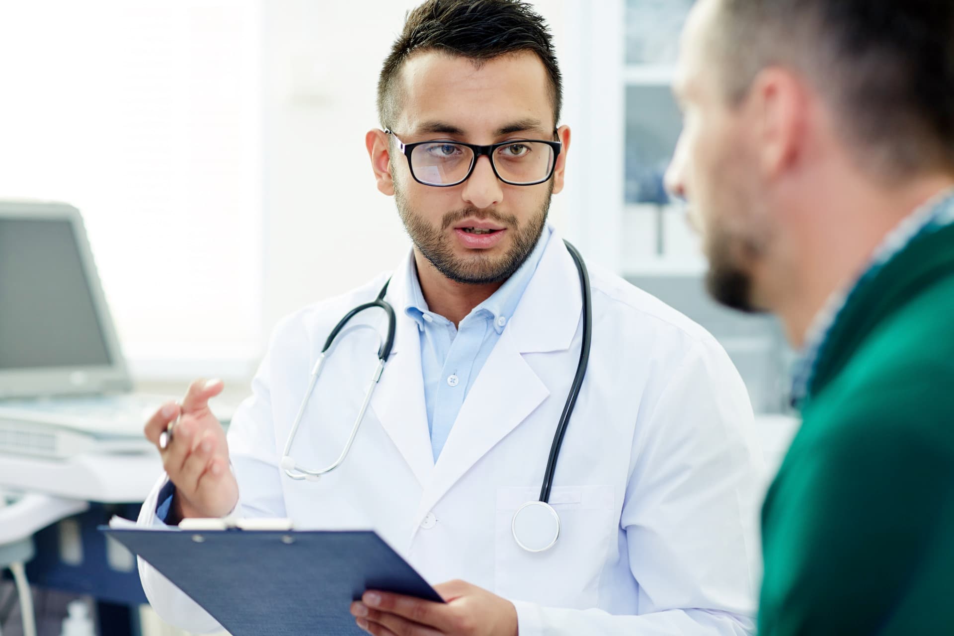 Clinician discussing musculoskeletal injection therapy with a patient